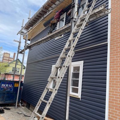 Expert roofing contractors working on home exterior renovation
